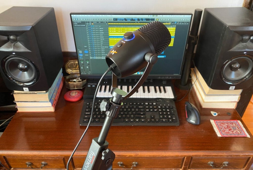 Neat Microphones Bumblebee II on a boom in front of a computer