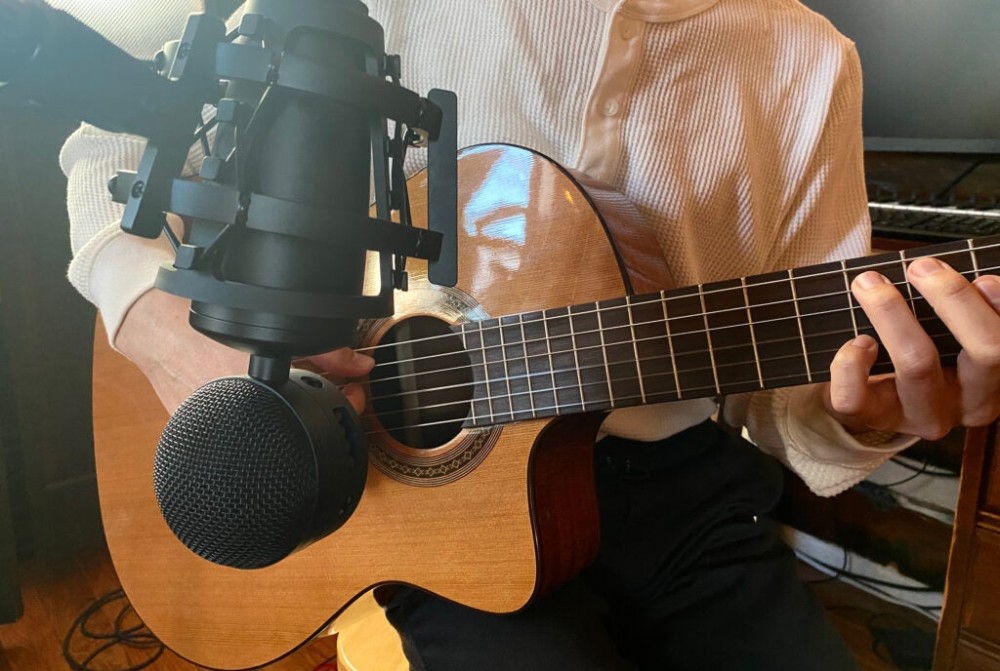 Neat Microphones King Bee II mounted in front of an acoustic guitar.