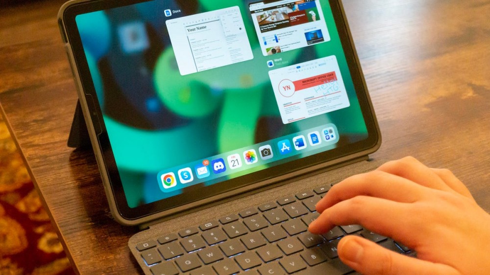 Person typing on the Apple iPad Air 4th-gen using the Logitech Combo Touch case